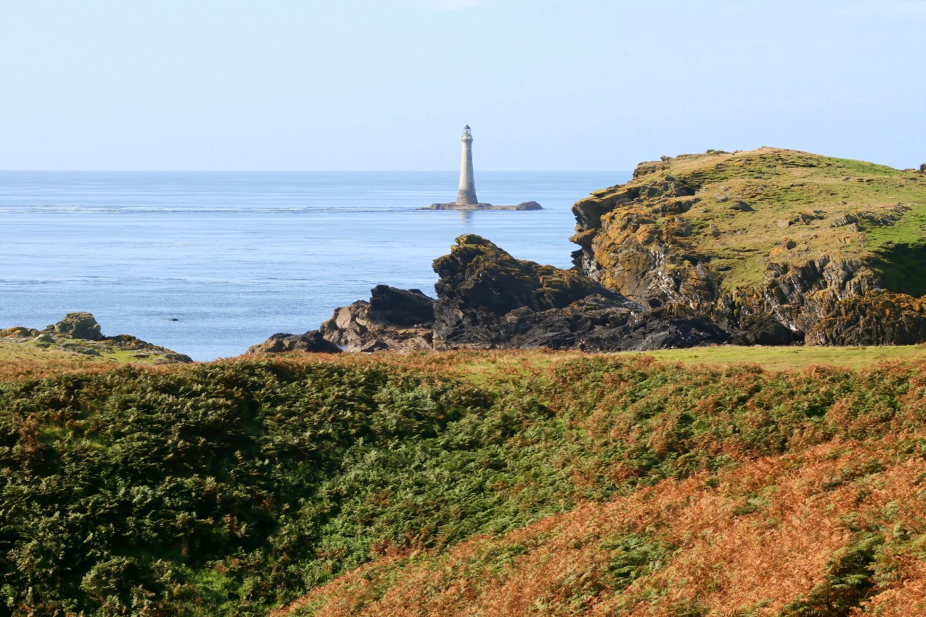 The historic stone lighthouse on Chicken Rock south of Calf of Man island, Isle of Man